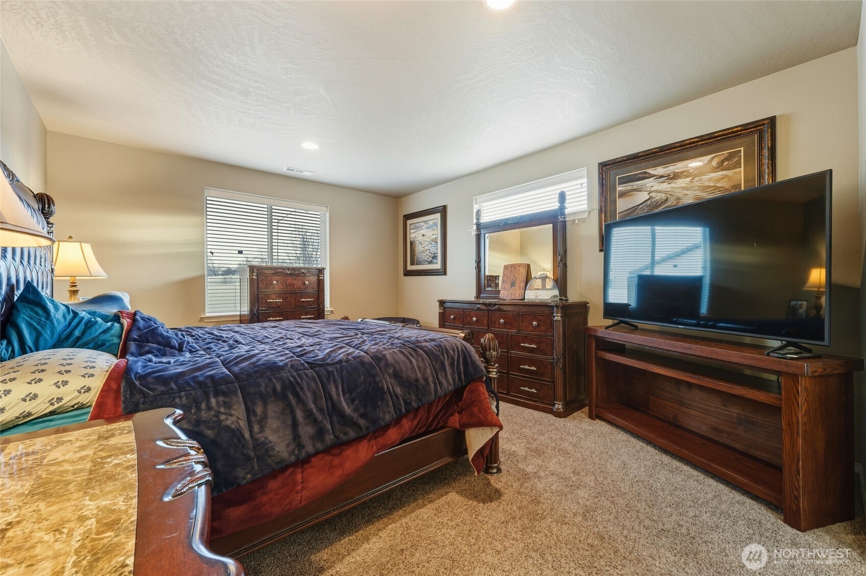 1397 Caprio Loop Walla Walla, WA 99362 - Photo 29 of 40 a spacious bedroom with a bed and large windows