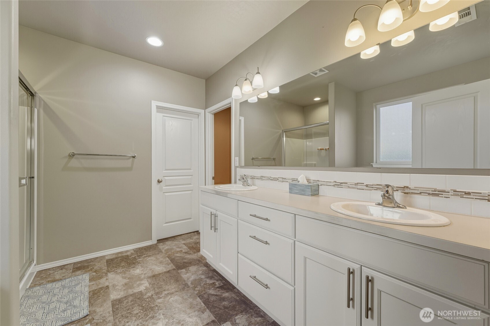 1397 Caprio Loop Walla Walla, WA 99362 - Photo 31 of 40 a bathroom with a double vanity sink and a mirror
