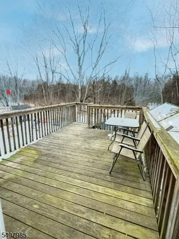 a view of balcony with wooden floor and outdoor seating
