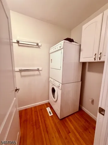 a view of a room with wooden floor