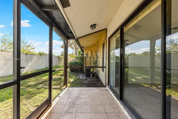 a view of a glass door with a trees from a window