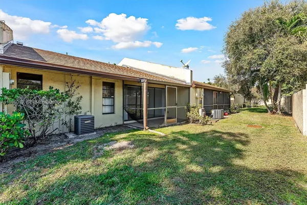 a view of a house with yard and sitting area