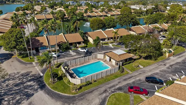 an aerial view of a house with a yard and lake view