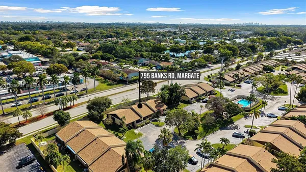 an aerial view of residential houses with outdoor space