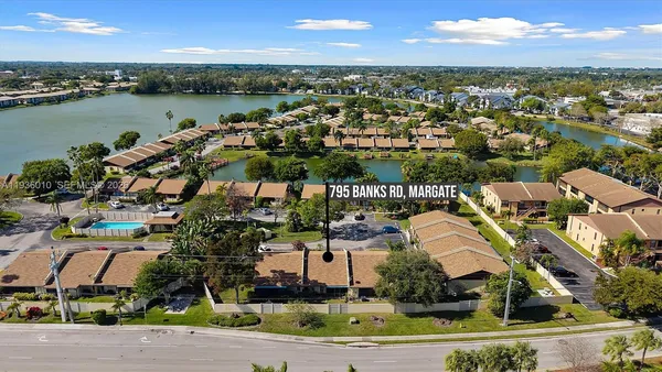 an aerial view of residential houses with outdoor space and river