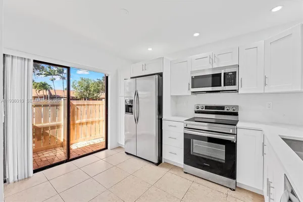 a kitchen with stainless steel appliances a stove sink and refrigerator