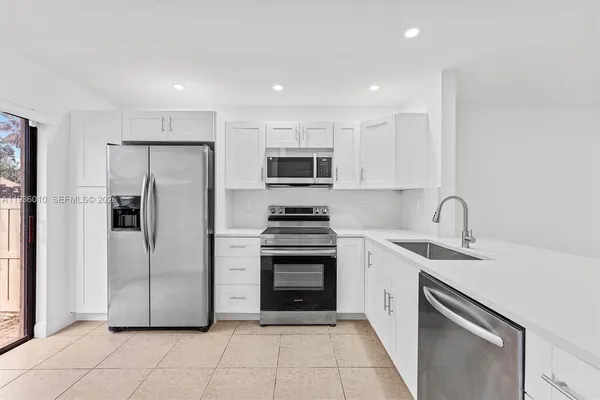 a kitchen with a sink stove and refrigerator