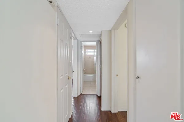a view of a hallway with wooden floor