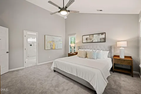 a spacious bedroom with a bed and a window
