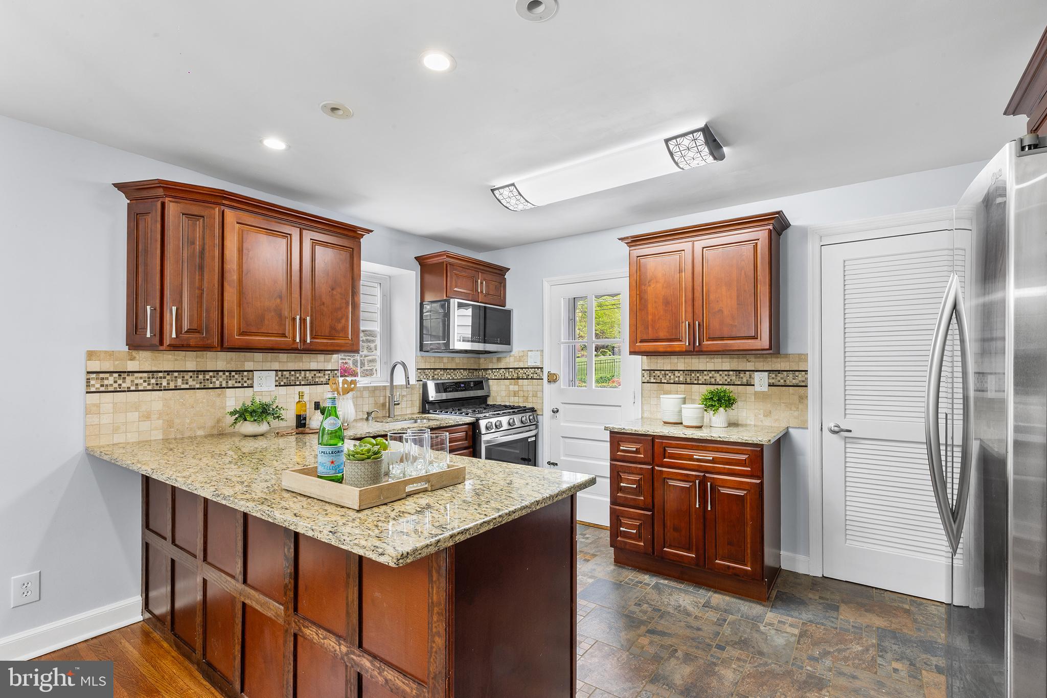 112 Rolling Road Bala Cynwyd, PA 19004 - Photo 12 of 39 a kitchen with stainless steel appliances granite countertop a sink stove and refrigerator