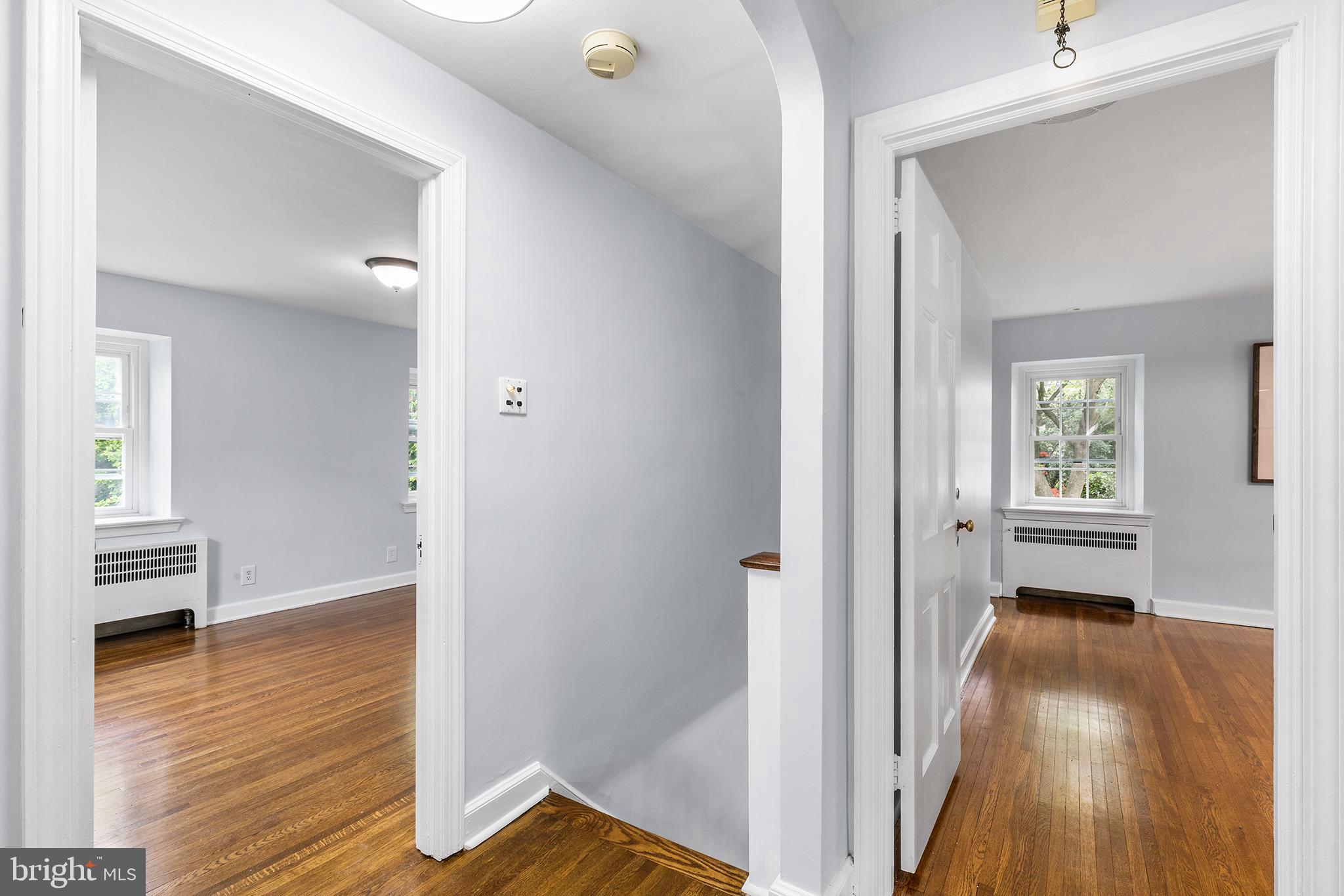 112 Rolling Road Bala Cynwyd, PA 19004 - Photo 15 of 39 a view of a hallway with wooden floor and a livingroom