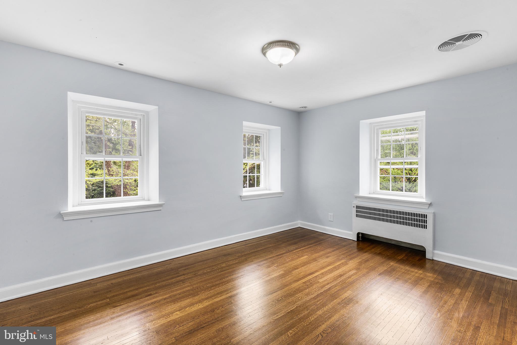 112 Rolling Road Bala Cynwyd, PA 19004 - Photo 21 of 39 a view of an empty room with wooden floor and a window