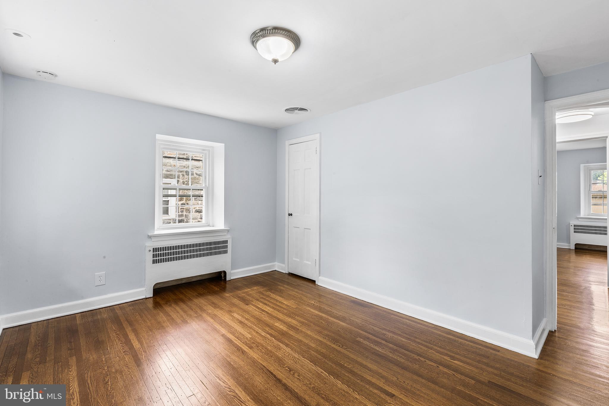 112 Rolling Road Bala Cynwyd, PA 19004 - Photo 22 of 39 an empty room with wooden floor and windows