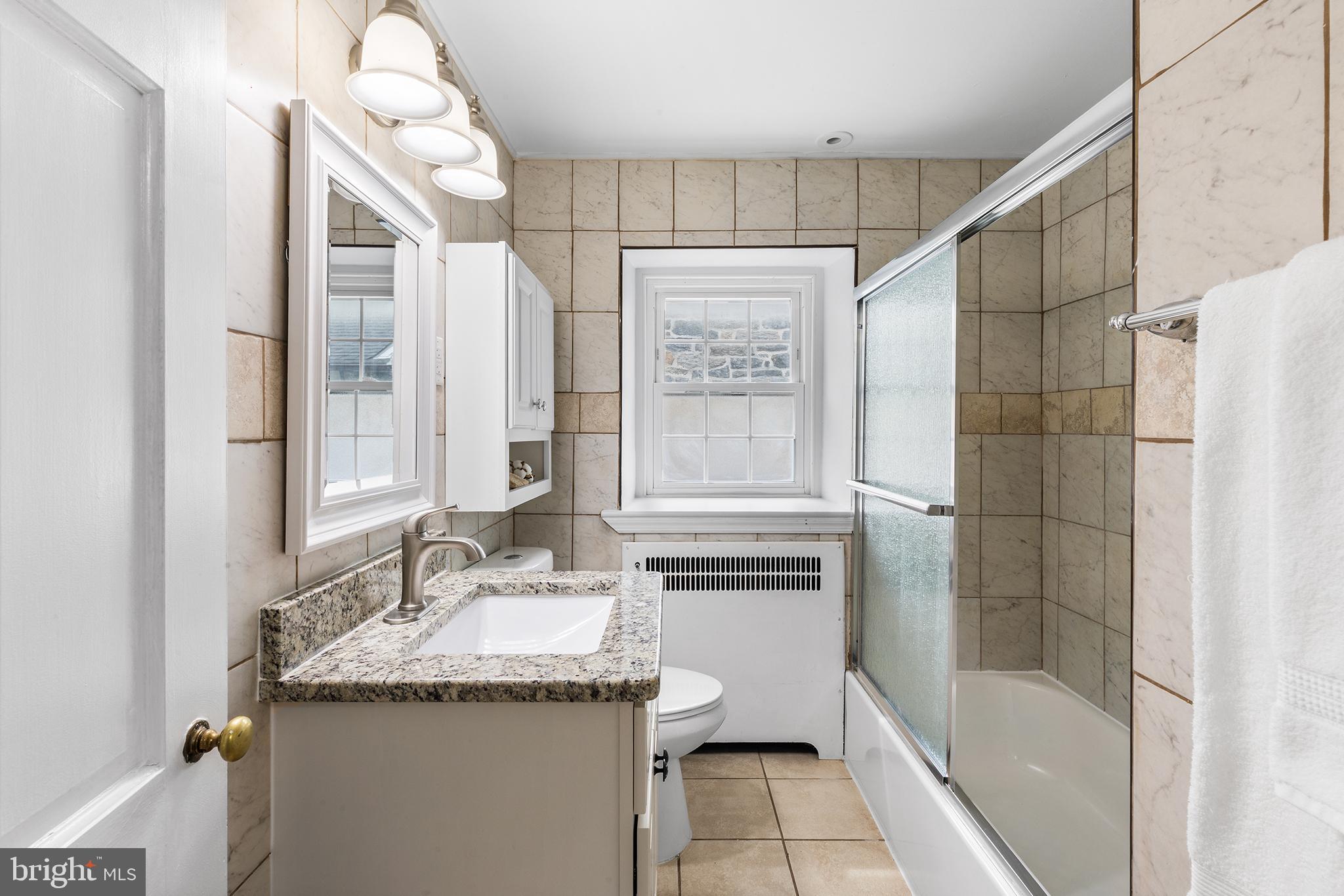 112 Rolling Road Bala Cynwyd, PA 19004 - Photo 23 of 39 a bathroom with a granite countertop sink a toilet and shower