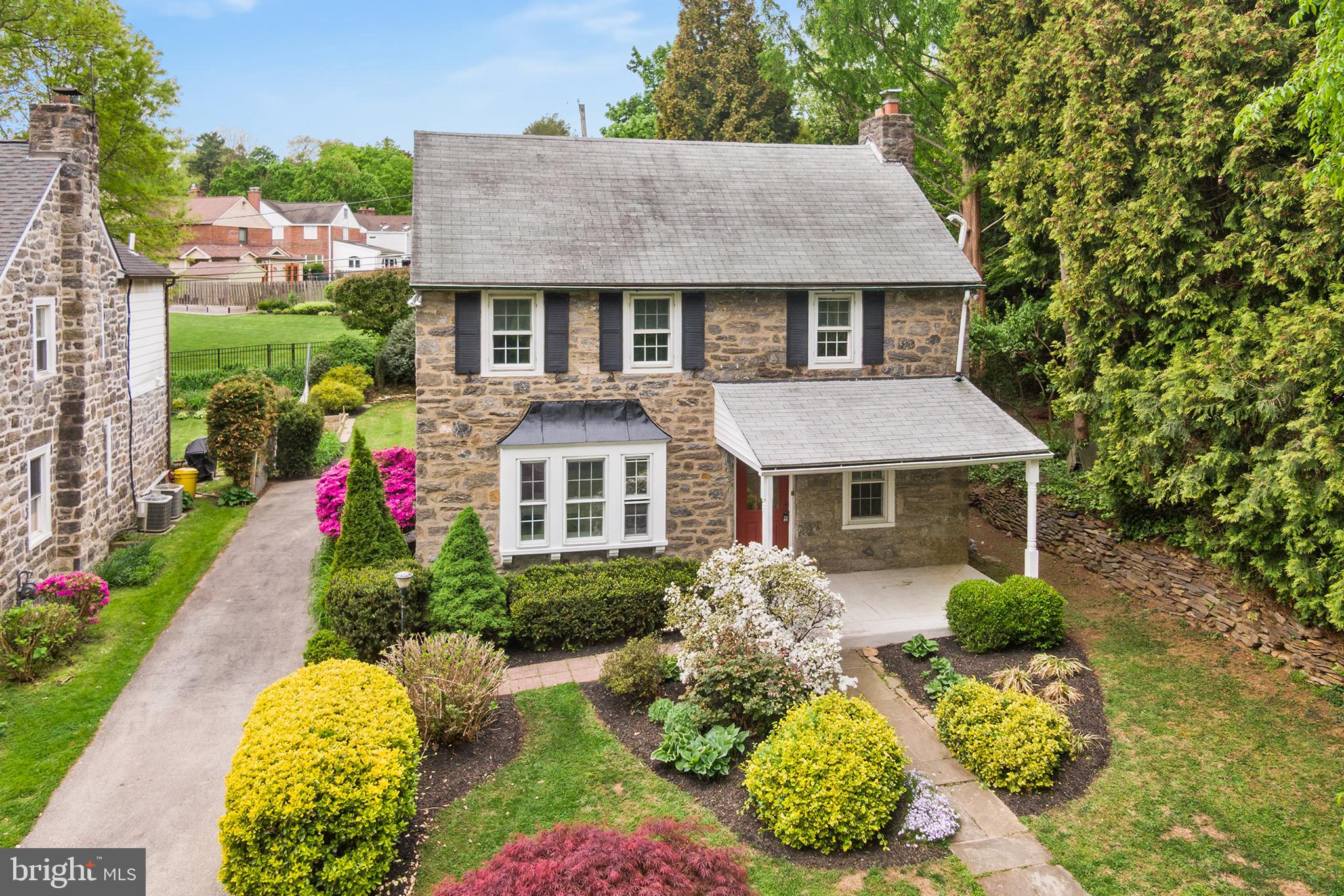 112 Rolling Road Bala Cynwyd, PA 19004 - Photo 37 of 39 a front view of a house with a yard and fountain