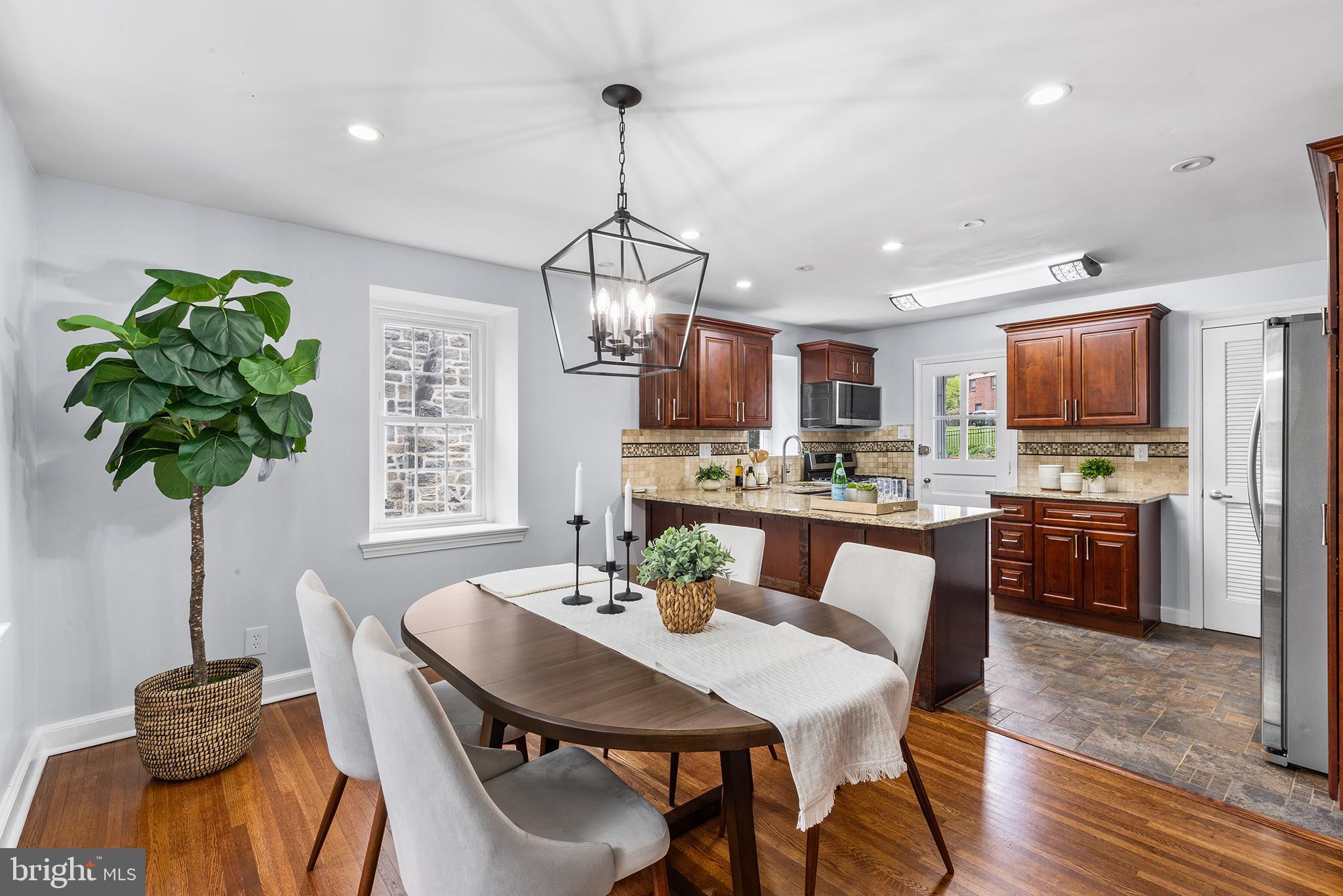112 Rolling Road Bala Cynwyd, PA 19004 - Photo 7 of 39 a view of a dining room with furniture a chandelier and wooden floor