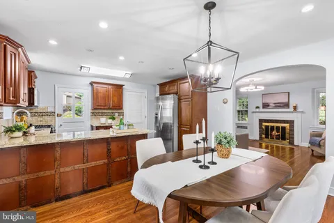a view of a dining room with furniture a chandelier and wooden floor