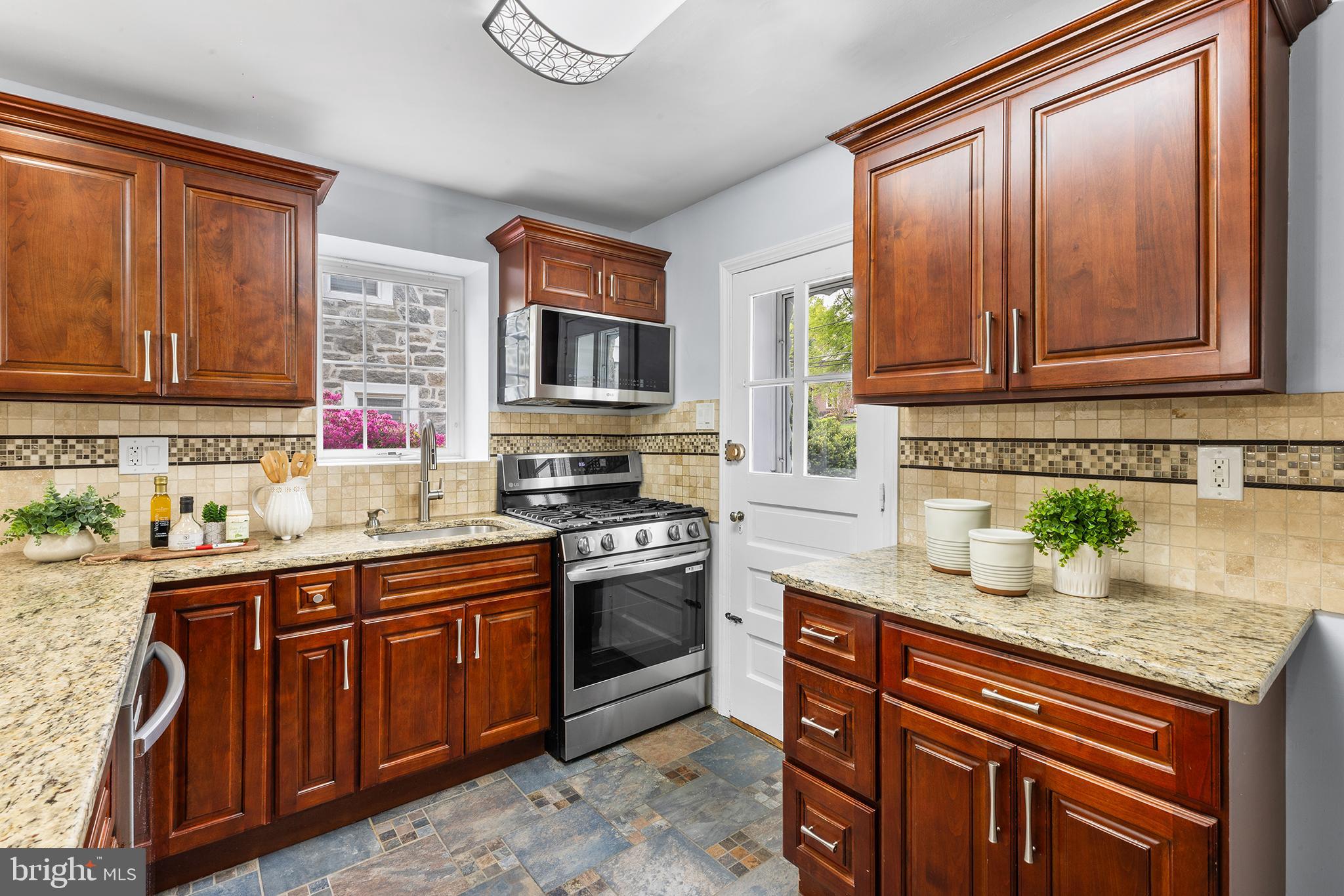 112 Rolling Road Bala Cynwyd, PA 19004 - Photo 9 of 39 a kitchen with stainless steel appliances granite countertop a sink stove and cabinets