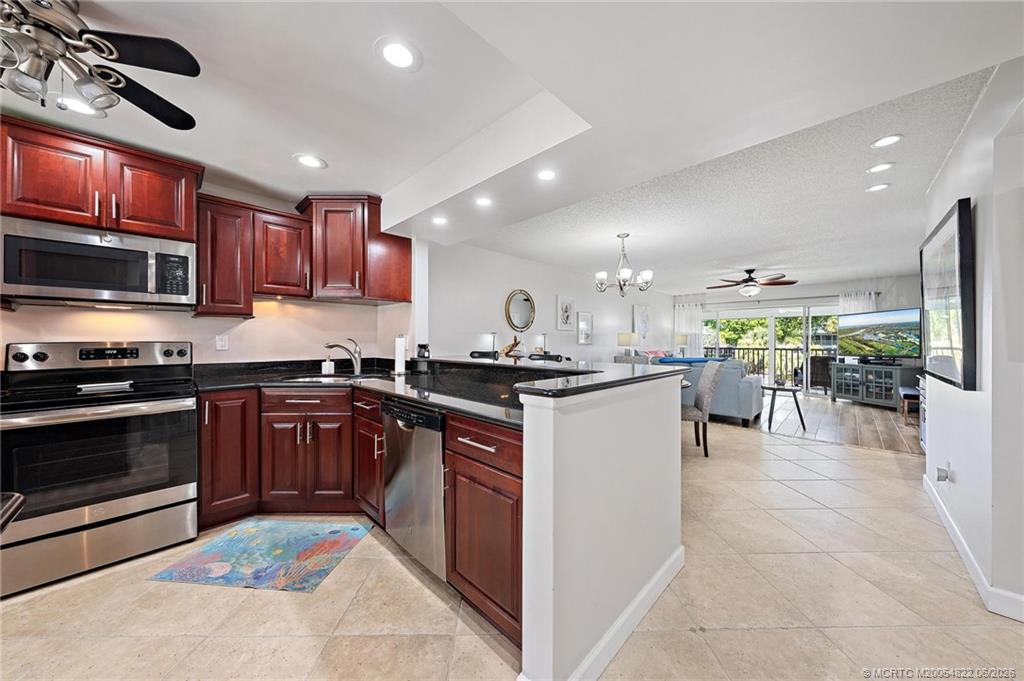 1862 Southwest Palm City Road, Unit 203 Stuart, FL 34994 - Photo 8 of 39 a kitchen with stainless steel appliances granite countertop a stove and a sink