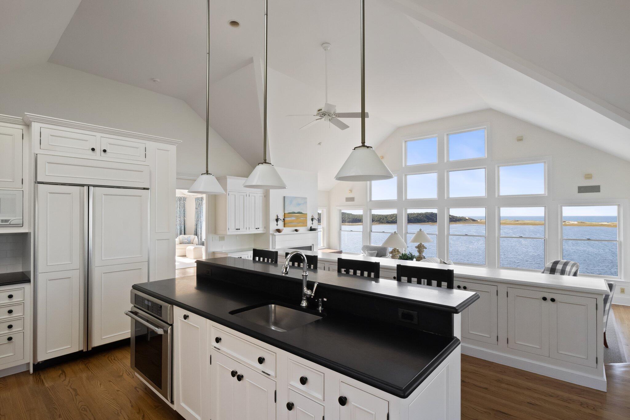 1035 Chequessett Neck Road Wellfleet, MA 02667 - Photo 13 of 86 a kitchen with stainless steel appliances granite countertop a sink a stove and a refrigerator