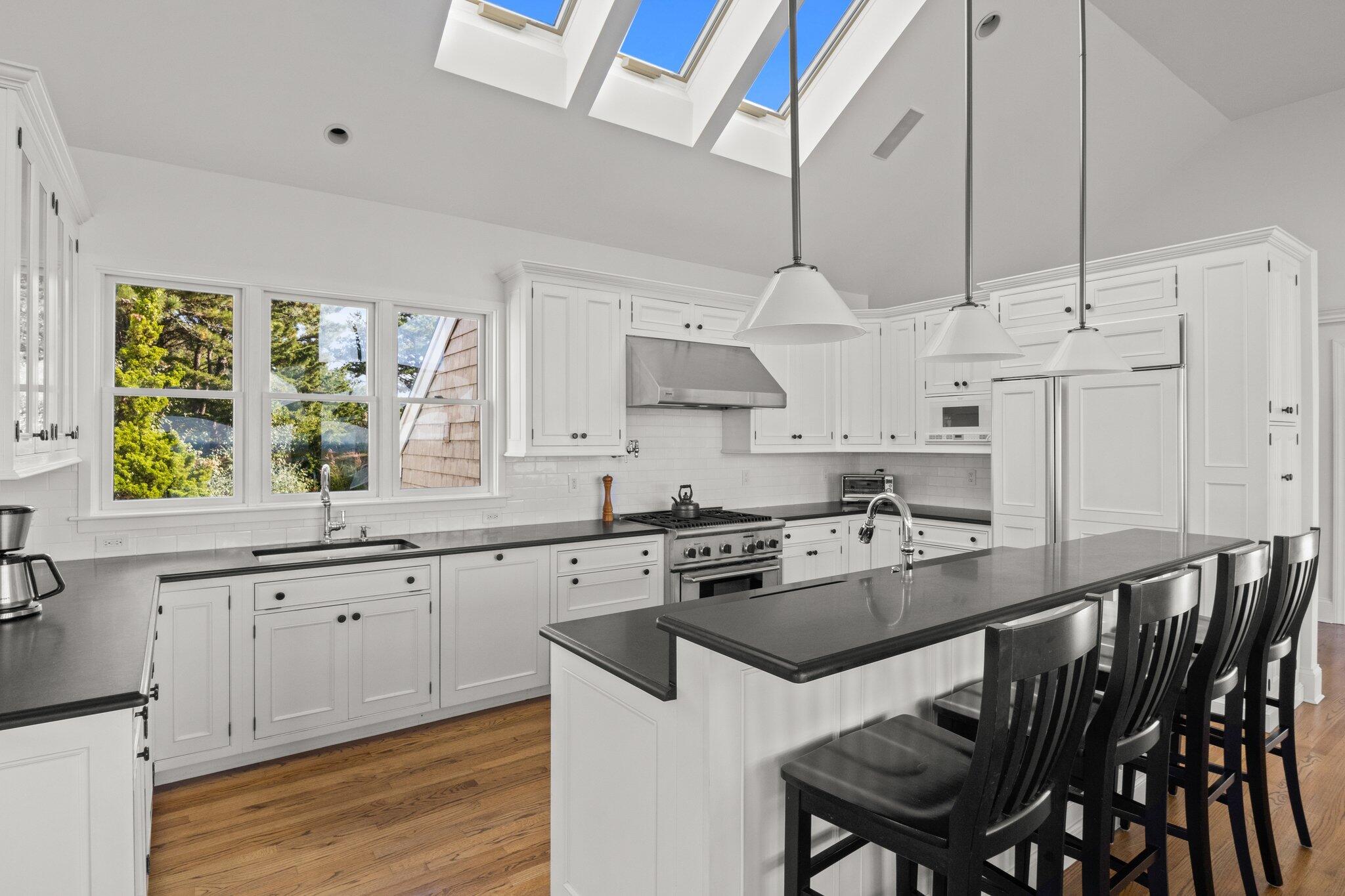 1035 Chequessett Neck Road Wellfleet, MA 02667 - Photo 15 of 86 a kitchen with stainless steel appliances granite countertop a stove a sink dishwasher and a refrigerator with wooden floor