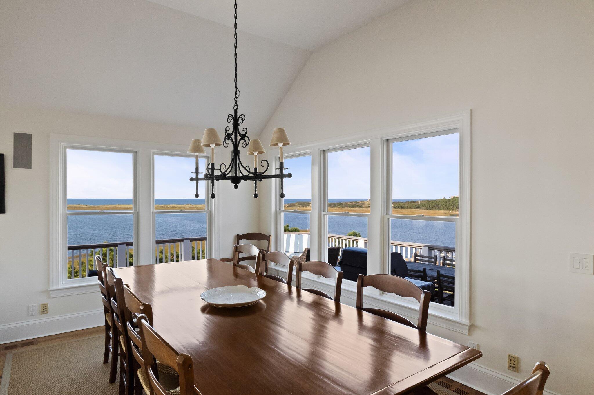 1035 Chequessett Neck Road Wellfleet, MA 02667 - Photo 18 of 86 a view of a dining room with furniture window and wooden floor