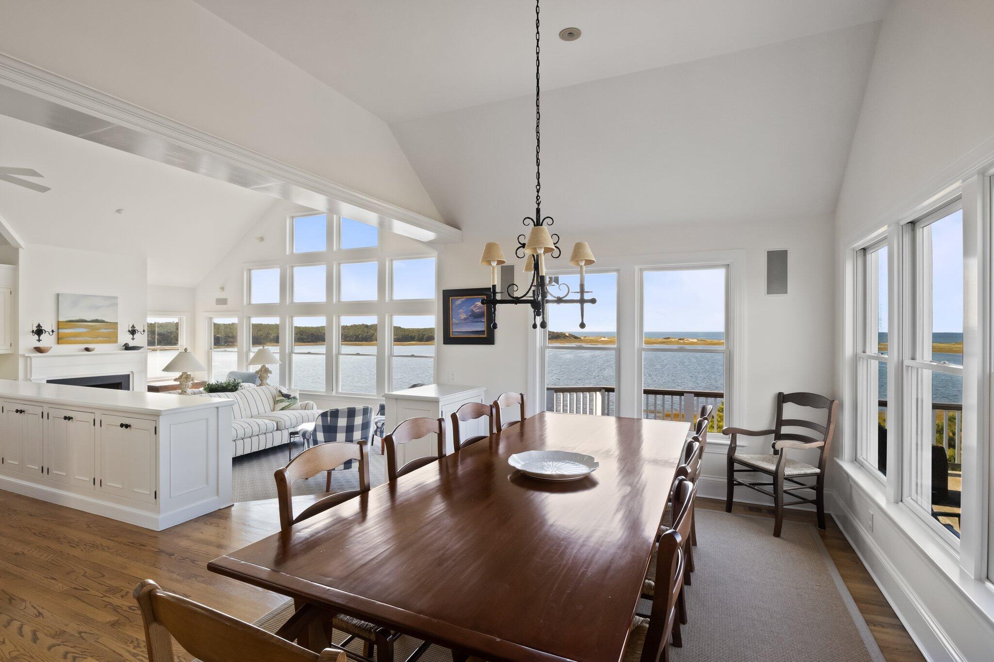 1035 Chequessett Neck Road Wellfleet, MA 02667 - Photo 19 of 86 a view of a dining room and livingroom with furniture wooden floor a chandelier