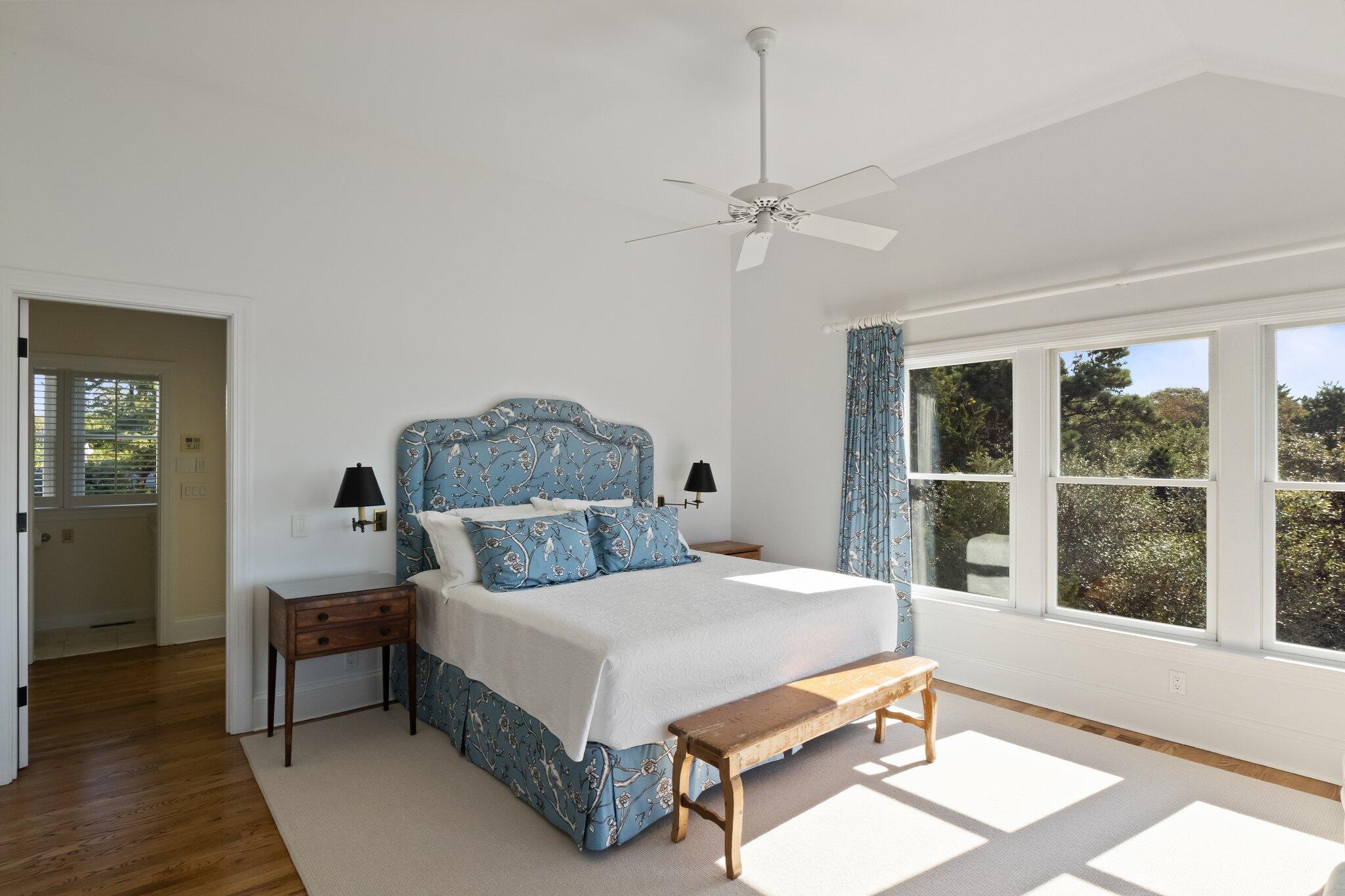 1035 Chequessett Neck Road Wellfleet, MA 02667 - Photo 30 of 86 a bedroom with a bed chandelier and a window