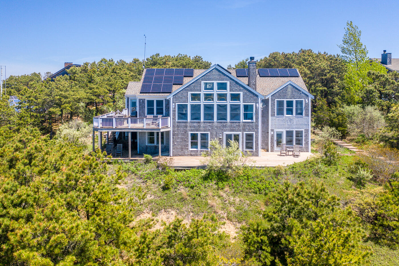 1035 Chequessett Neck Road Wellfleet, MA 02667 - Photo 3 of 86 a front view of a house with a yard