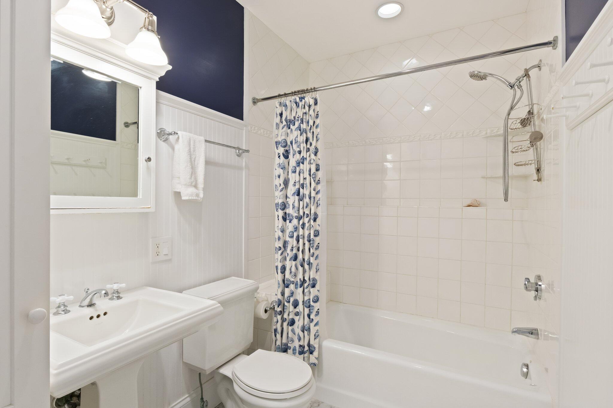 1035 Chequessett Neck Road Wellfleet, MA 02667 - Photo 50 of 86 a bathroom with a bathtub shower sink vanity and toilet