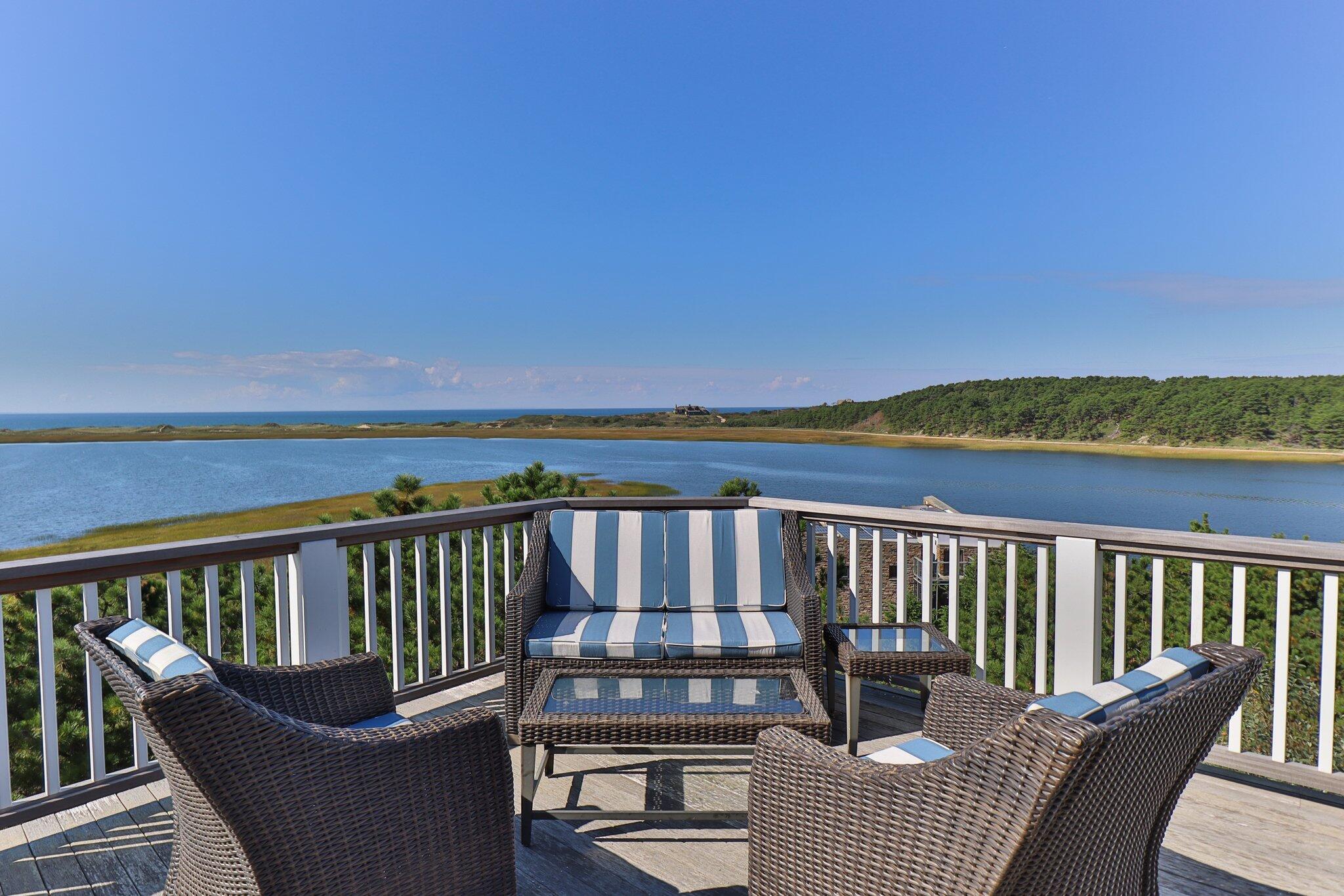1035 Chequessett Neck Road Wellfleet, MA 02667 - Photo 58 of 86 a balcony with wooden floor and outdoor seating