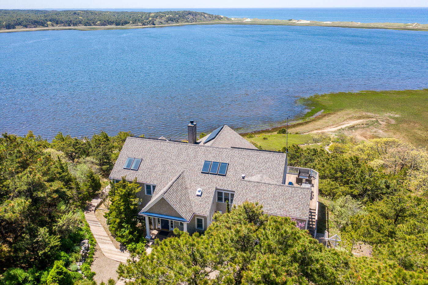 1035 Chequessett Neck Road Wellfleet, MA 02667 - Photo 77 of 86 an aerial view of a house with a garden and lake view