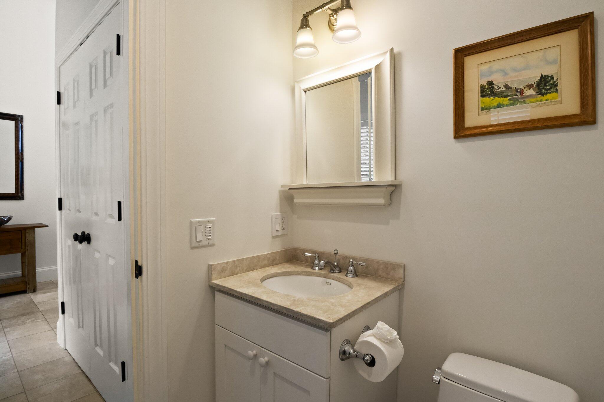 1035 Chequessett Neck Road Wellfleet, MA 02667 - Photo 8 of 86 a bathroom with a granite countertop sink mirror and toilet