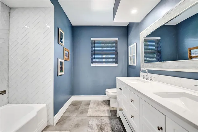 a bathroom with a sink a vanity and a bathtub