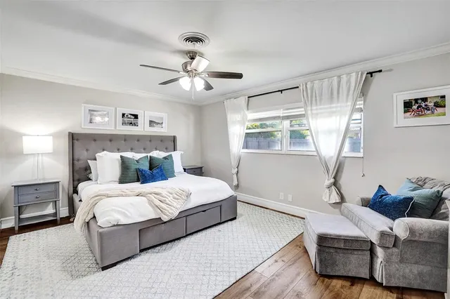 a bedroom with a large bed couch and window