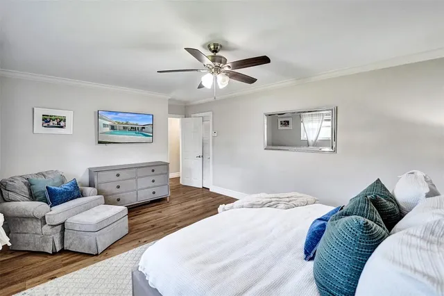 a bedroom with a bed couch and window