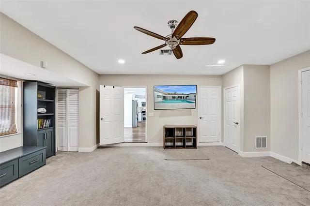 a living room with furniture and a ceiling fan