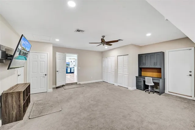 a view of a livingroom with furniture and a ceiling fan