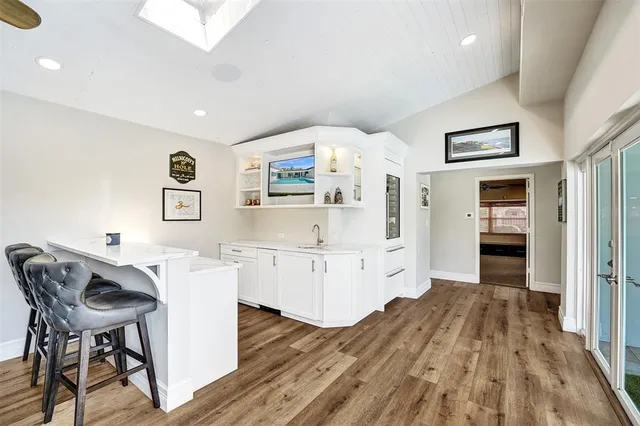 a open kitchen with white cabinets and stainless steel appliances