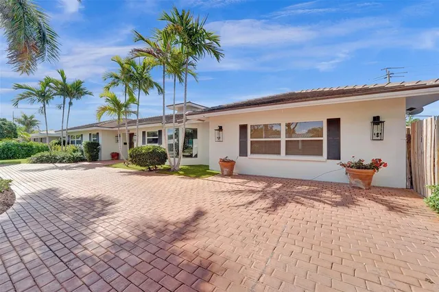 a house with palm tree in front of it