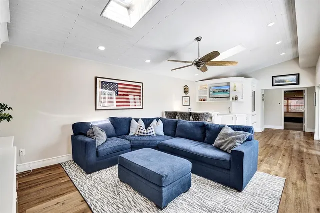 a living room with furniture ceiling fan and a rug