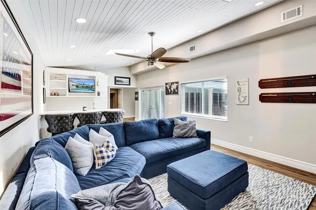a living room with furniture ceiling fan and a window