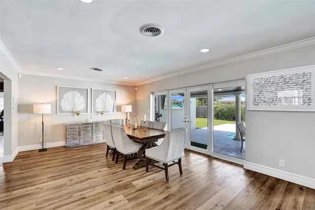 a dining room with furniture and wooden floor