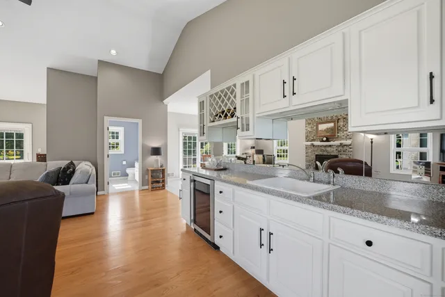 a large kitchen with stainless steel appliances granite countertop a lot of counter space and wooden floors