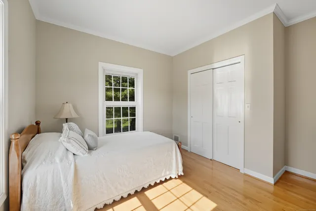 a bed sitting in a bedroom next to a window