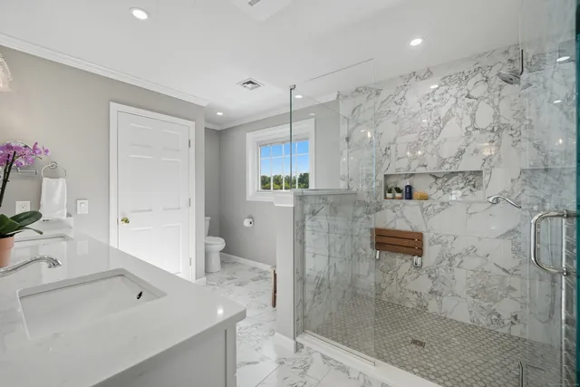 a bathroom with a shower sink and mirror