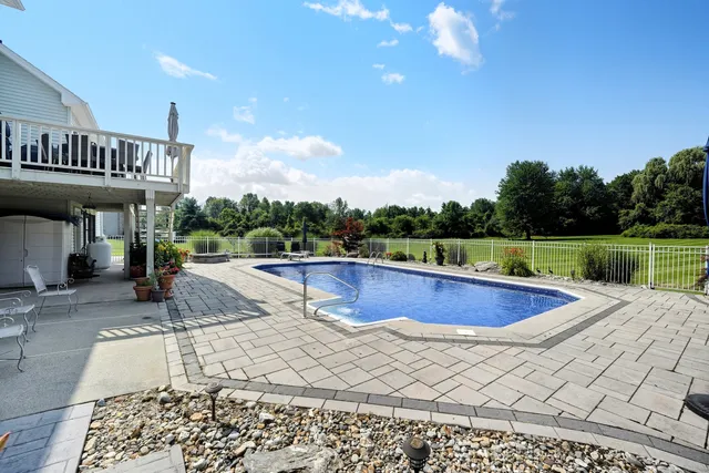 a view of a swimming pool and lounge chairs