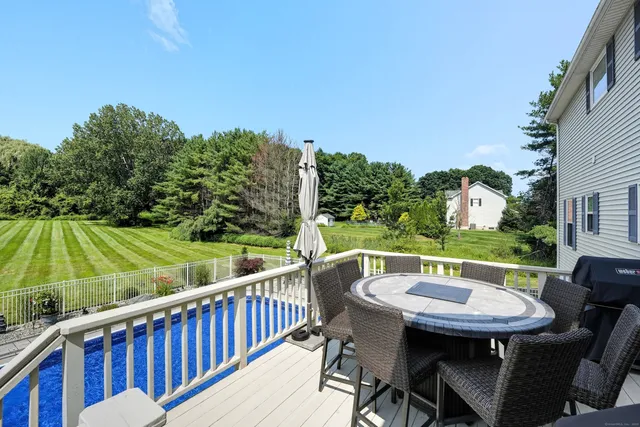 a view of a balcony with a table and chairs
