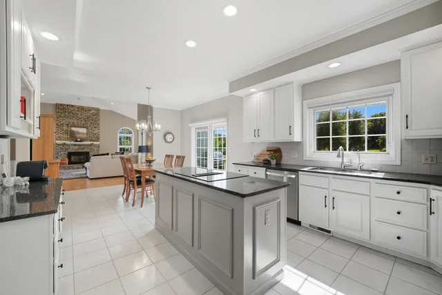 a kitchen with cabinets and chairs
