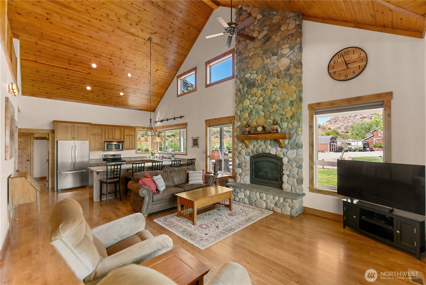 23 George Road Omak, WA 98841 - Photo 12 of 40 a living room with furniture a flat screen tv and a fireplace